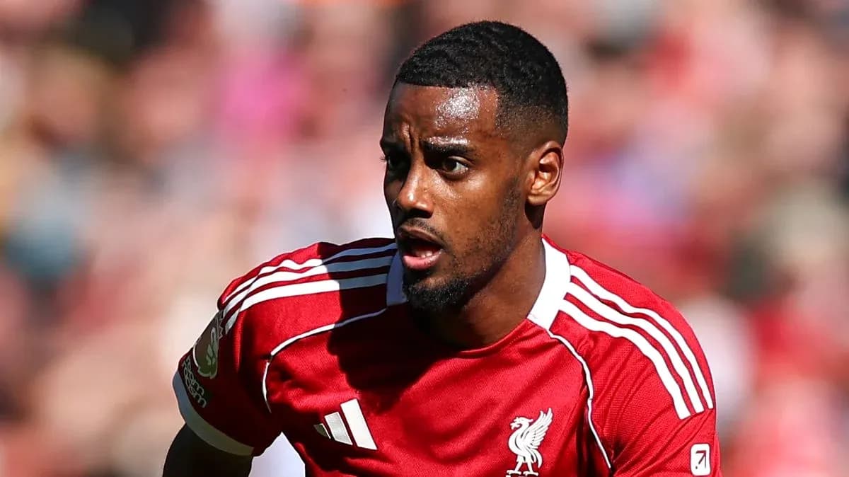 Player in red Liverpool kit running on pitch