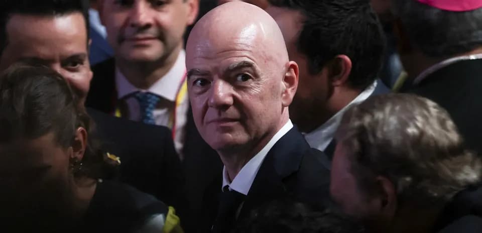Man in suit surrounded by people at event