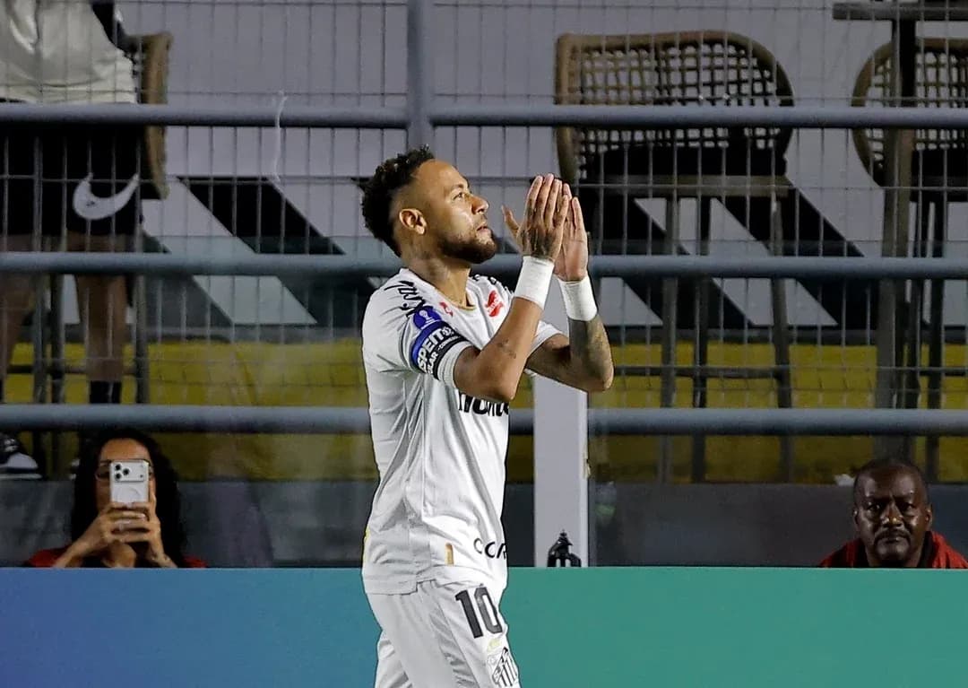 Neymar celebrating during match with fans in background