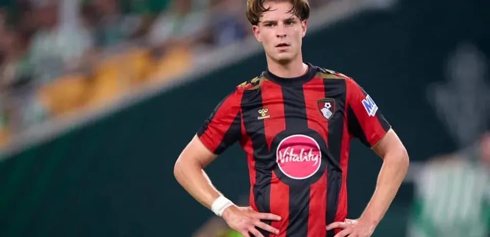 Player in Bournemouth kit standing on the field