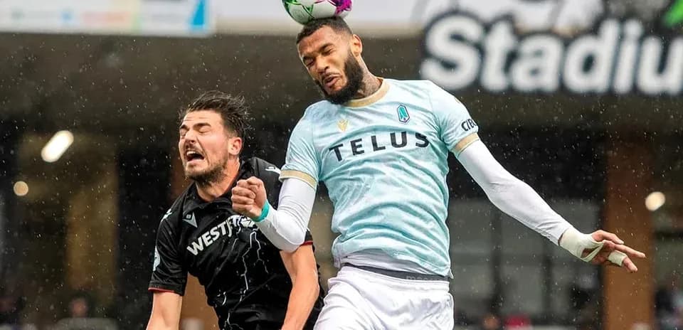 Player heading the ball during Pacific FC match