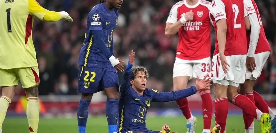 Player on the ground during match, teammates nearby