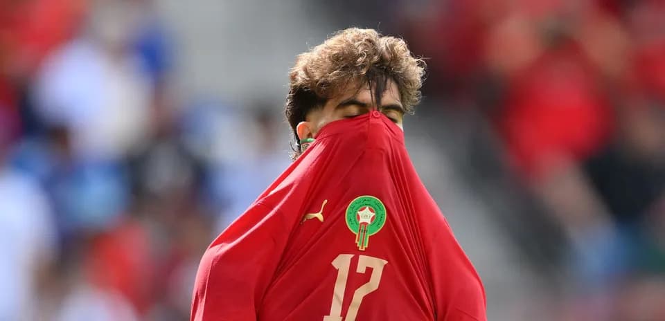 Player covering face with jersey during match