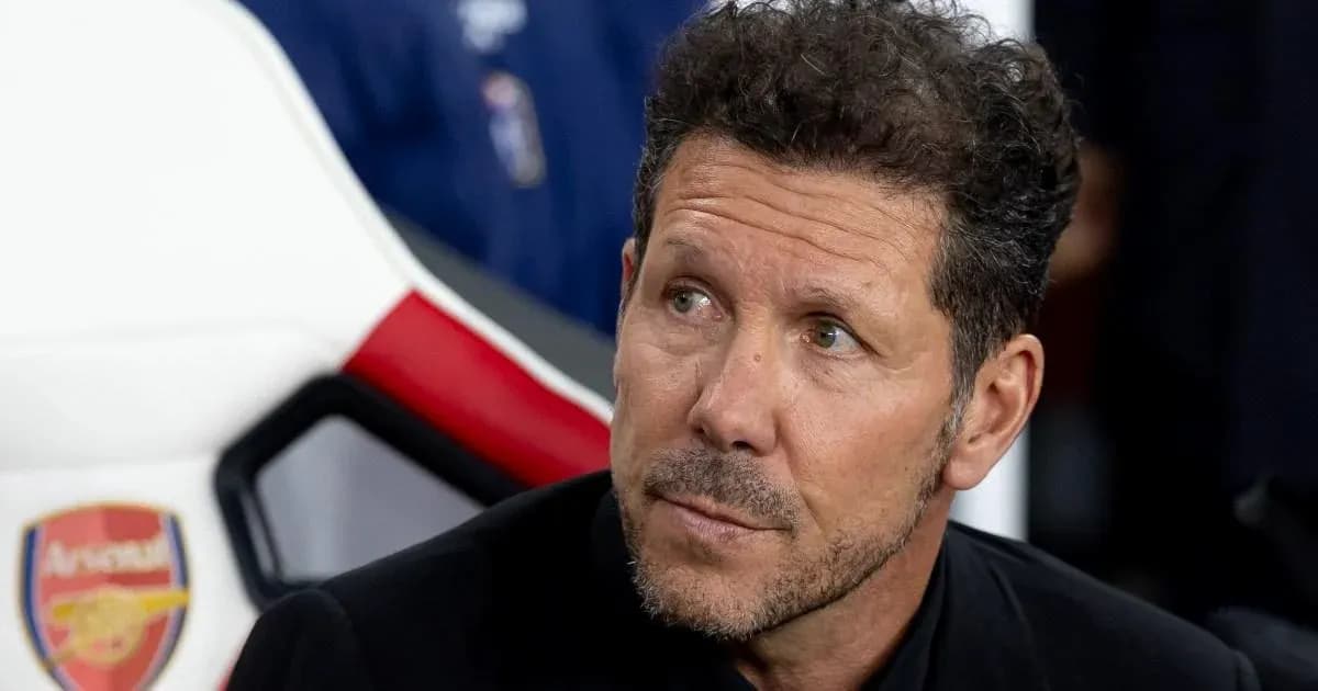 Coach seated on bench during match preparation