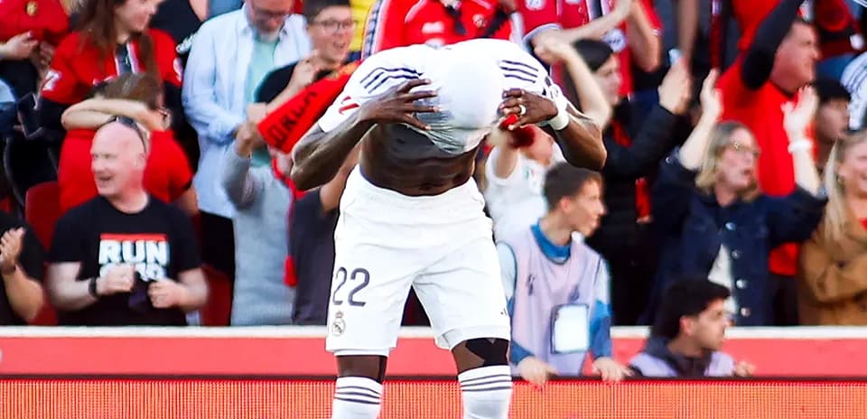 Player celebrating with fans after scoring a goal