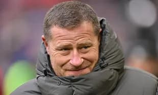 Coach wearing a puffy jacket on the sidelines