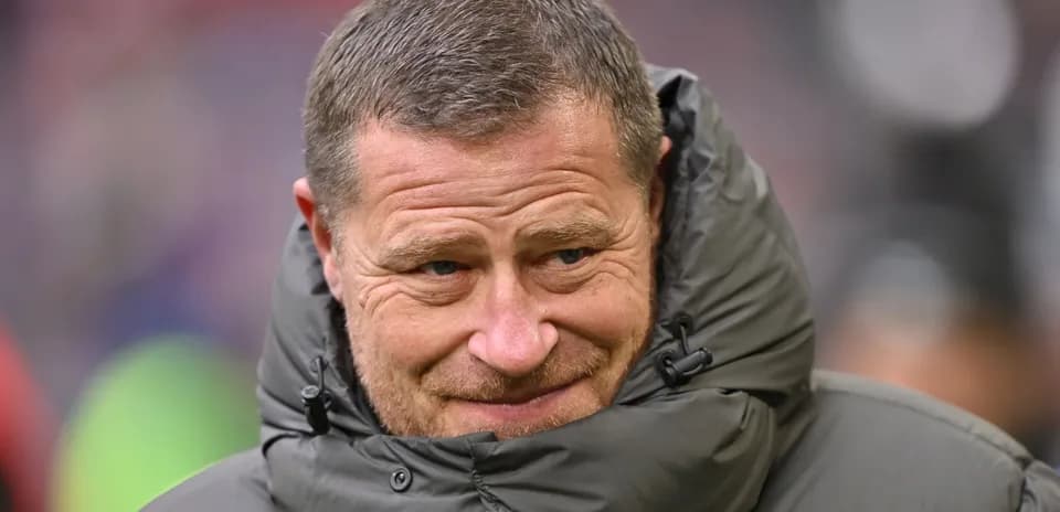 Coach wearing a puffy jacket on the sidelines