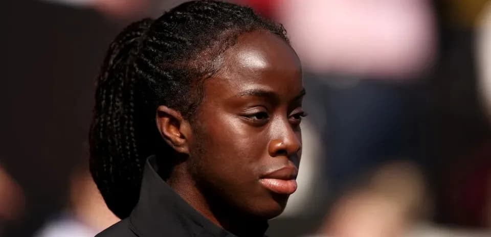 Athlete with braided hair on the sidelines