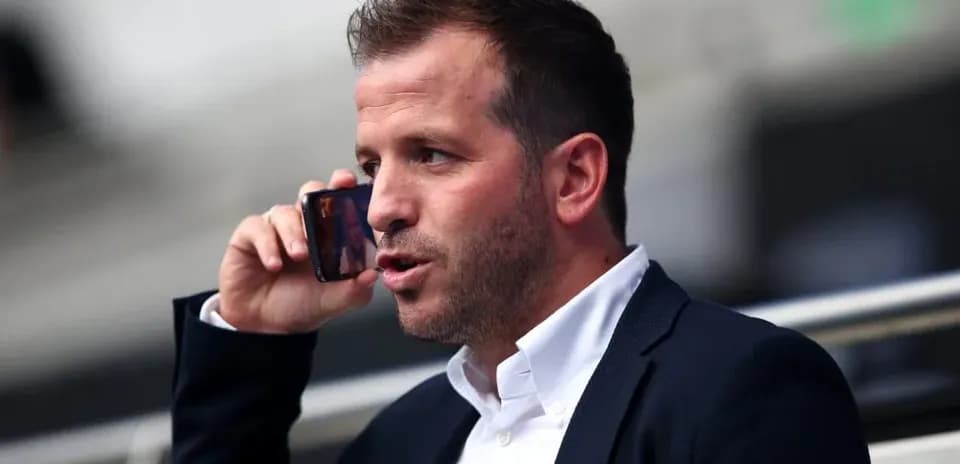 Man talking on the phone in a stadium