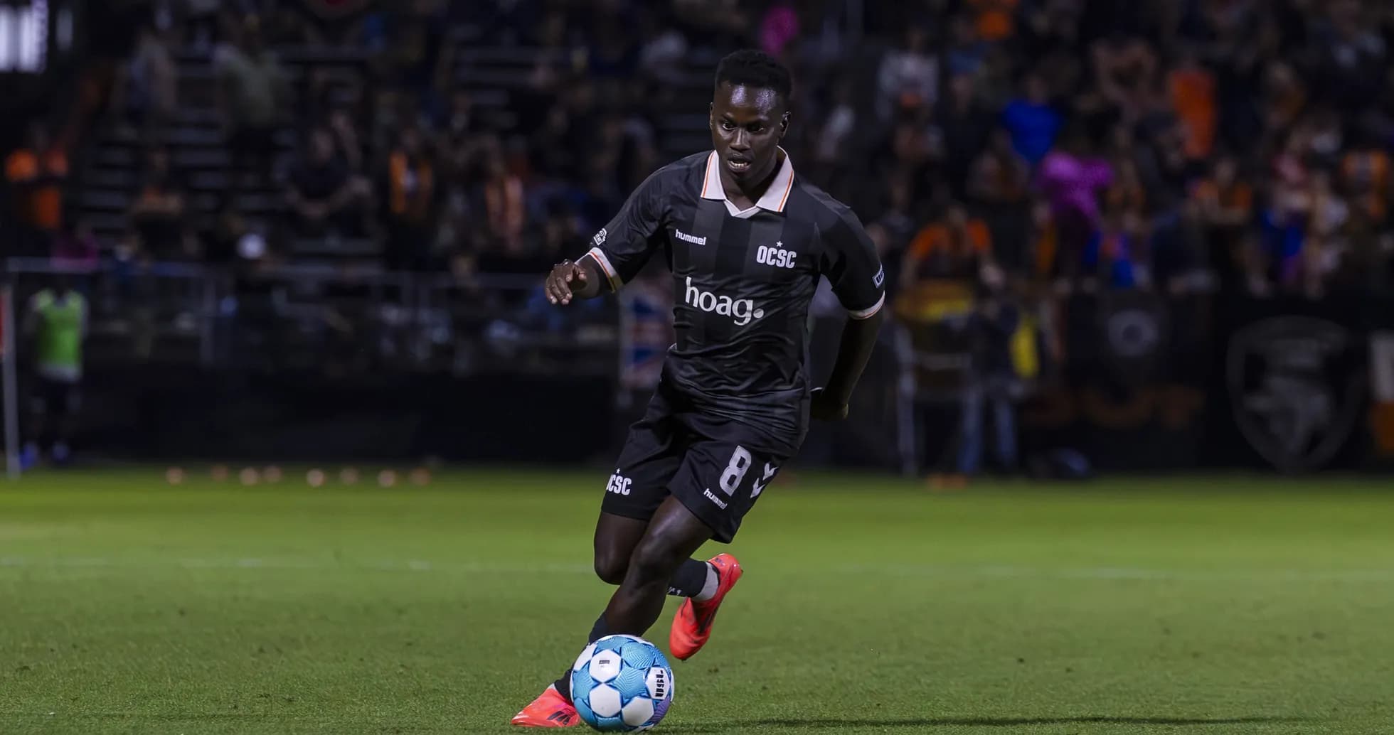 Player dribbling the ball during USL Championship match