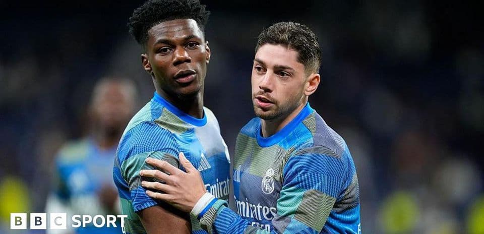 Two Real Madrid players celebrating on the field