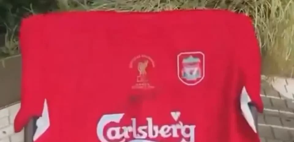 Liverpool jersey with Carlsberg logo displayed outdoors