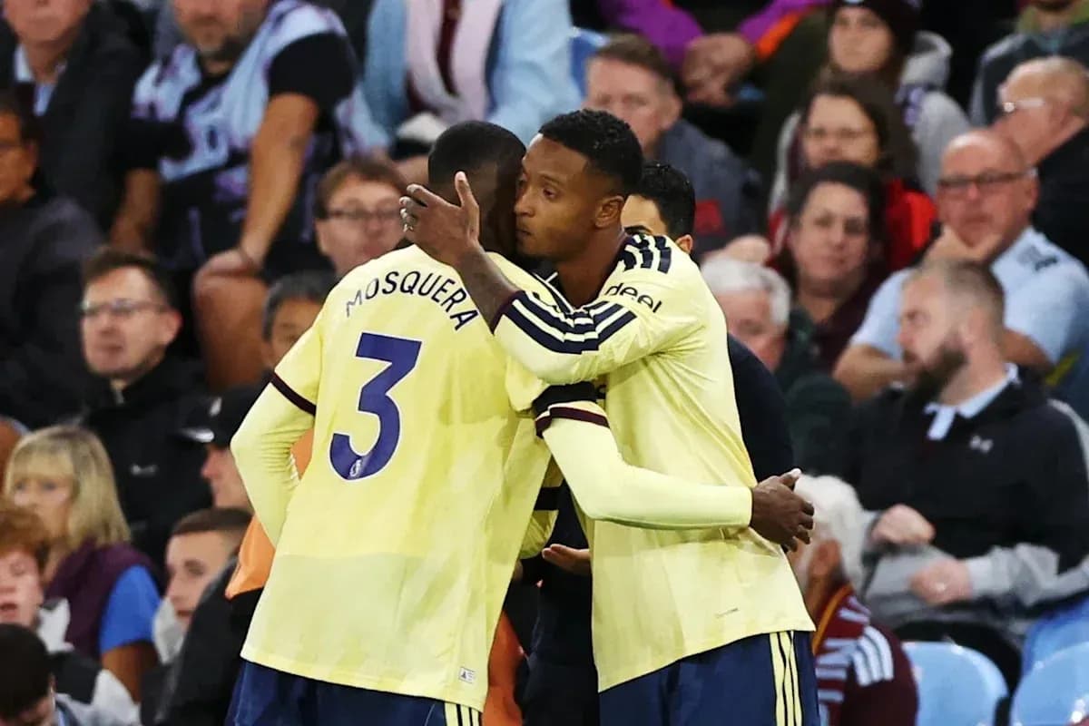 Two players embracing on the sidelines during match