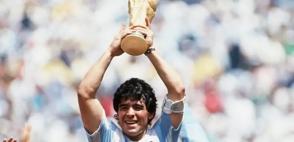 Player holding World Cup trophy in celebration