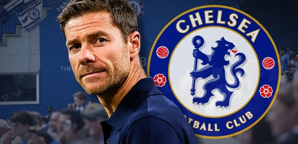 Man standing in front of Chelsea FC logo