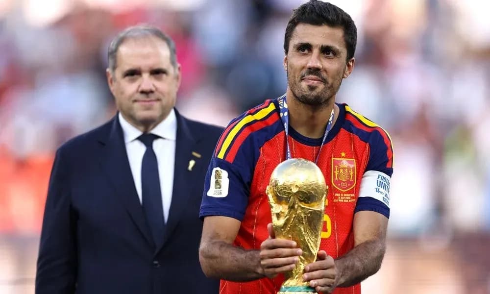 Player holding World Cup trophy with official nearby