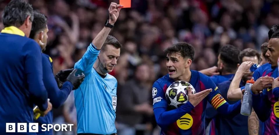 Referee showing red card to player during match