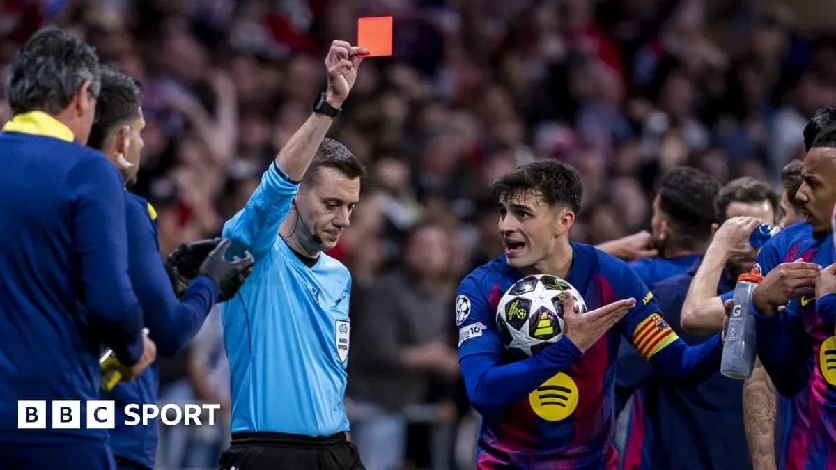 Referee showing red card to player during match
