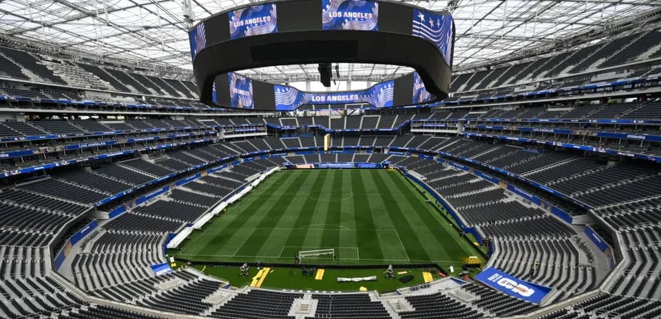 Empty stadium with field and large screens overhead
