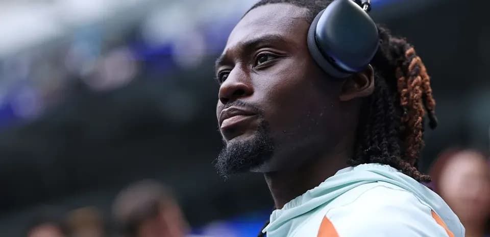 Player wearing headphones on the sidelines
