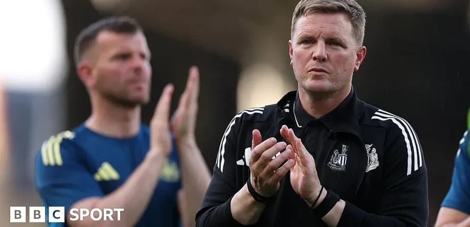 Coach clapping with player in background during match