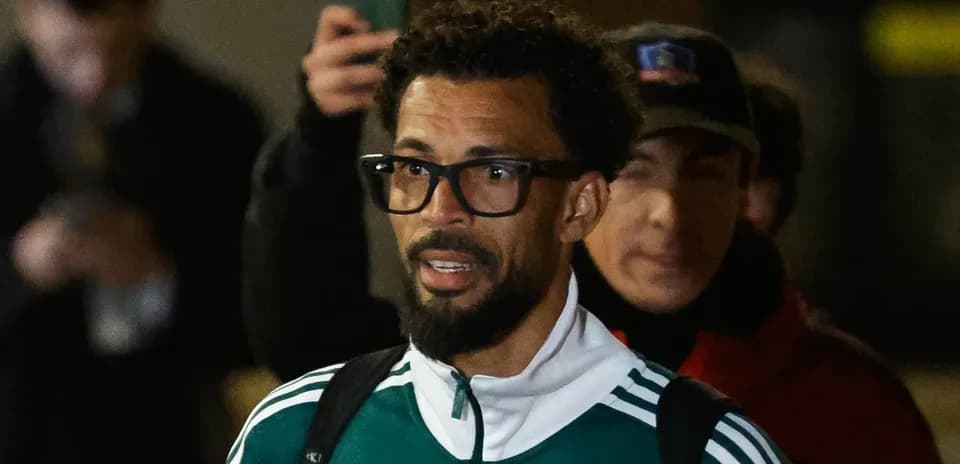 Player in green jacket arriving at event