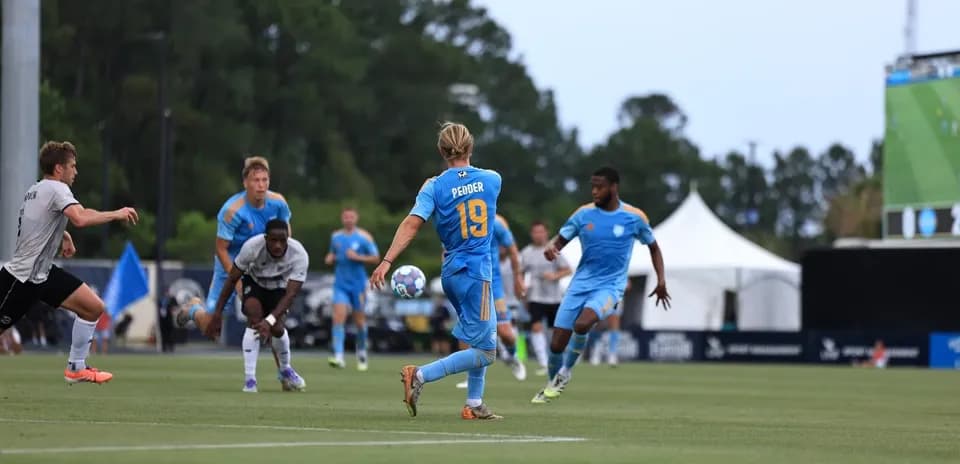 Player passing the ball during JAX match