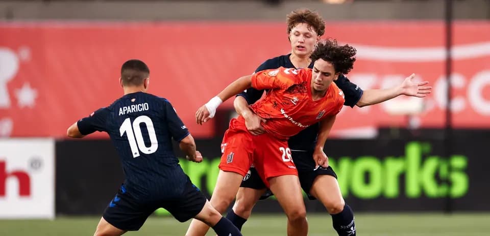 Players competing for the ball during match