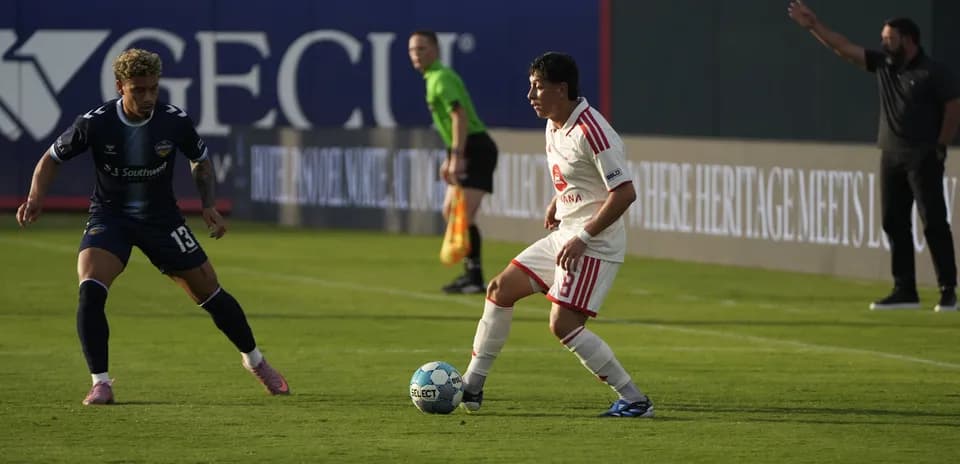 Players competing for the ball in match