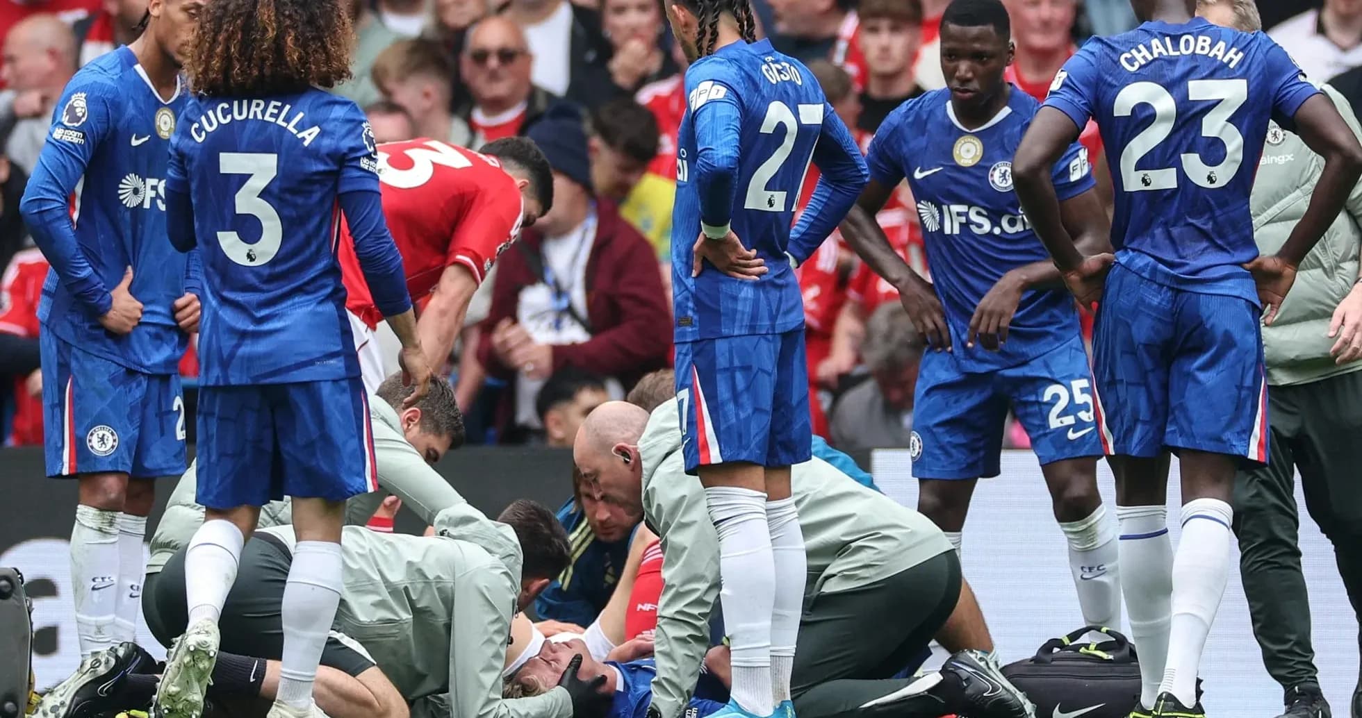 Players gathered around injured teammate on field