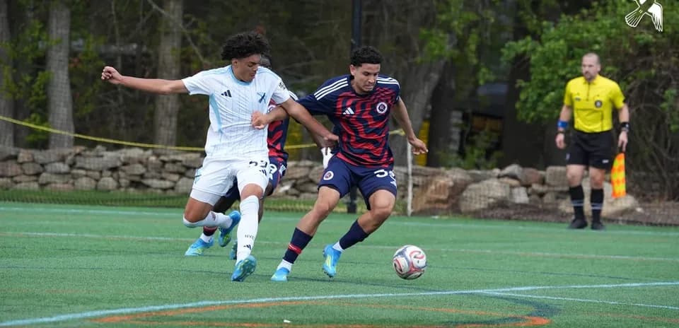 Players competing for the ball in MLS Next Pro match