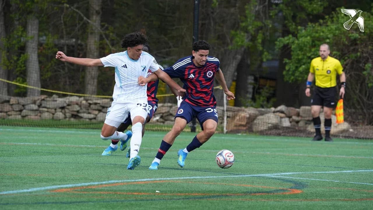 Players competing for the ball in MLS Next Pro match