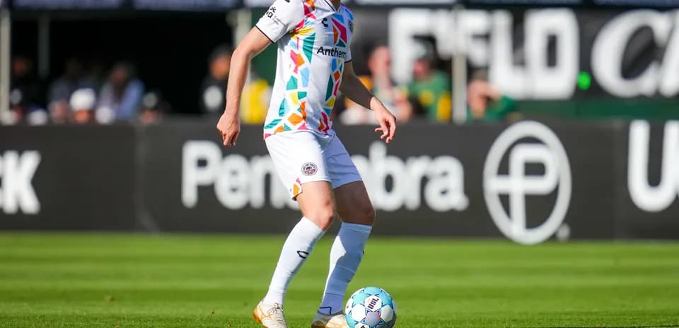 Player dribbling the ball on the field
