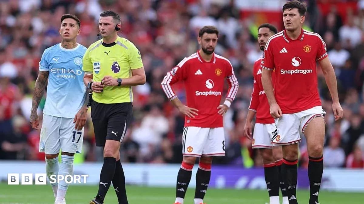 Players and referee during Manchester derby match