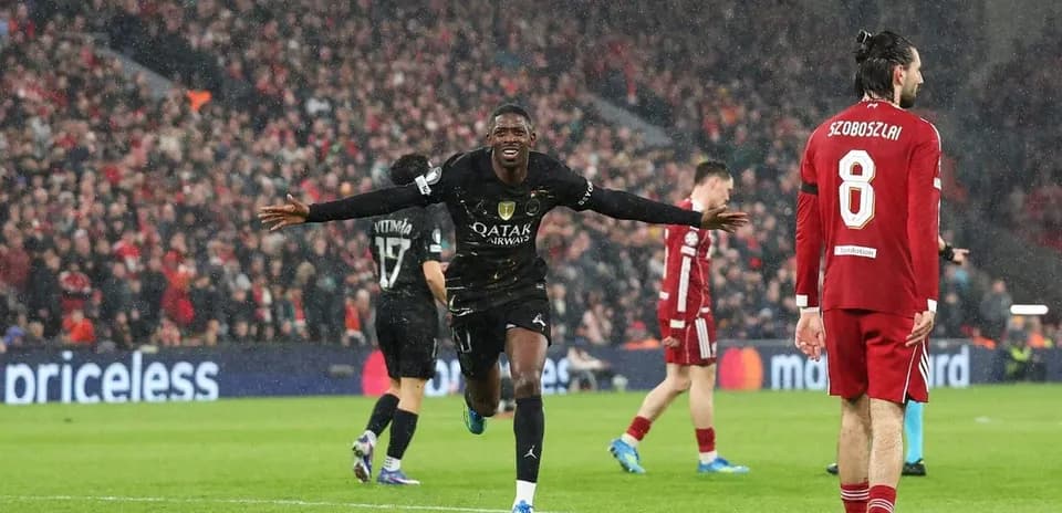 Player celebrating a goal in a rainy match
