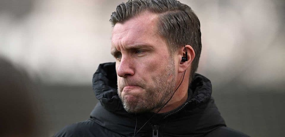 Coach wearing earphones during training session