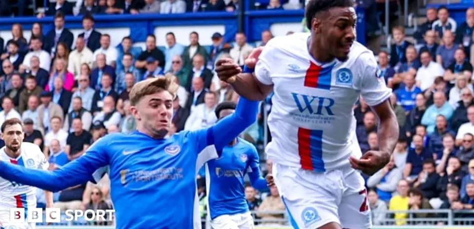 Player in blue attempting to tackle player in white