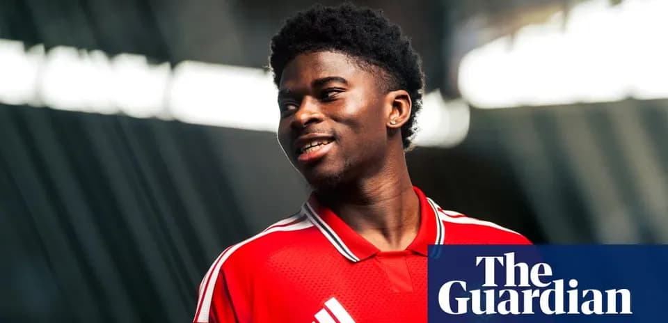 Player wearing red jersey smiling during photo shoot