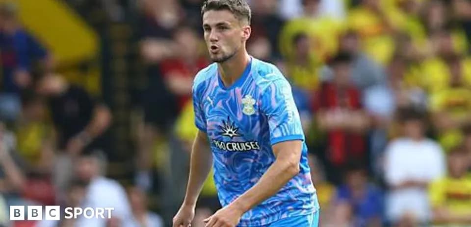 Player in blue kit during match at stadium
