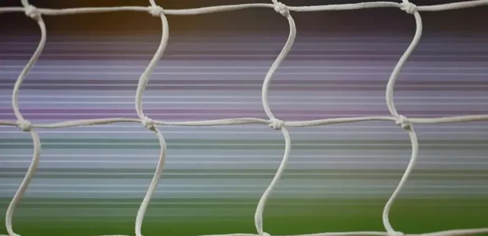 Close-up of soccer net with blurred background