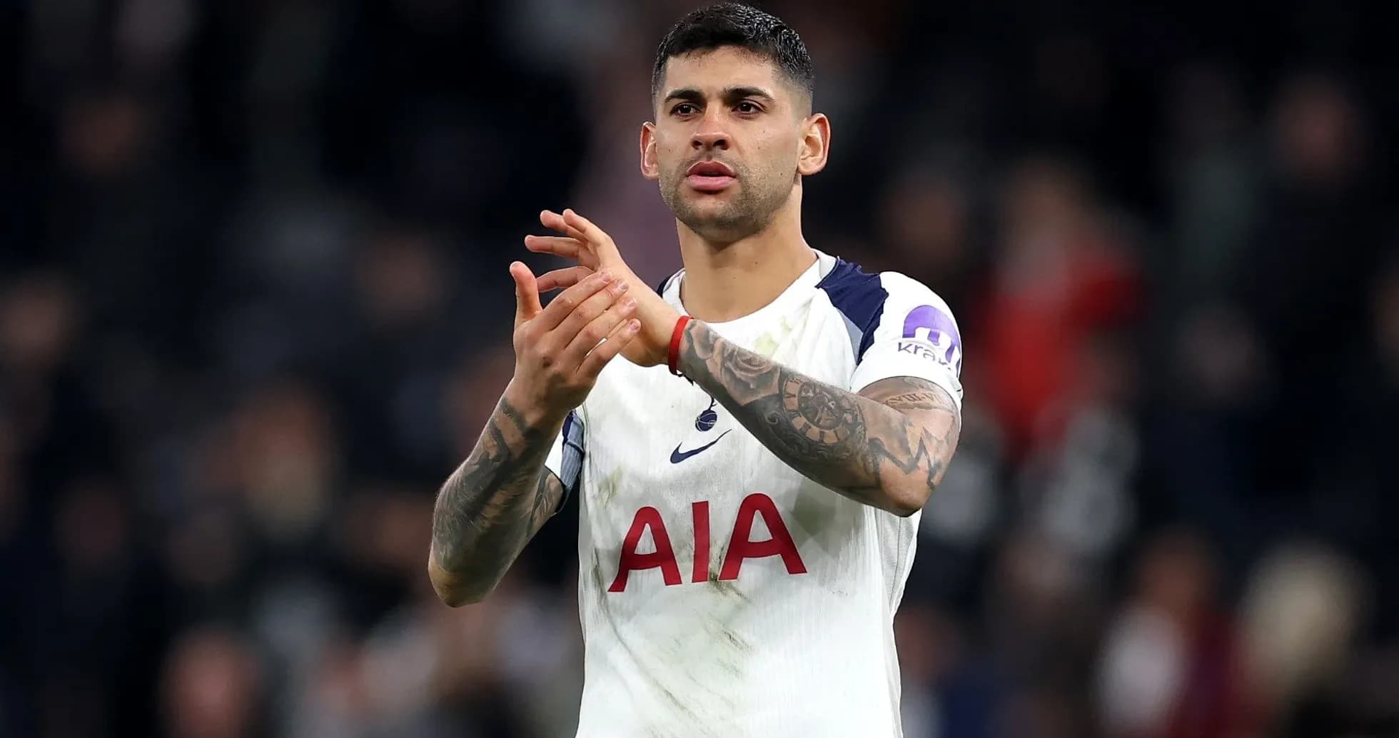 Player applauding fans after a match