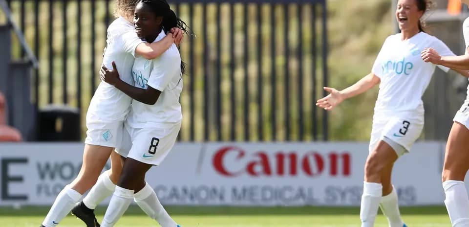 Players celebrating a goal during FA WSL match