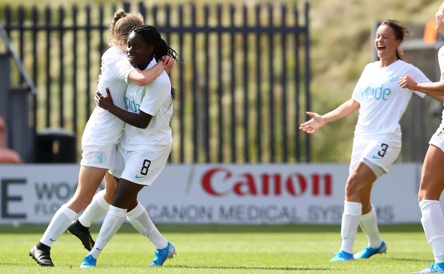 Players celebrating a goal during FA WSL match