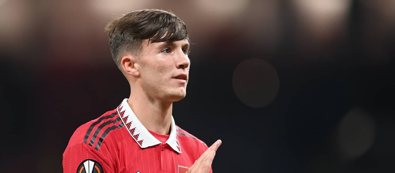 Player in red jersey gesturing during a match