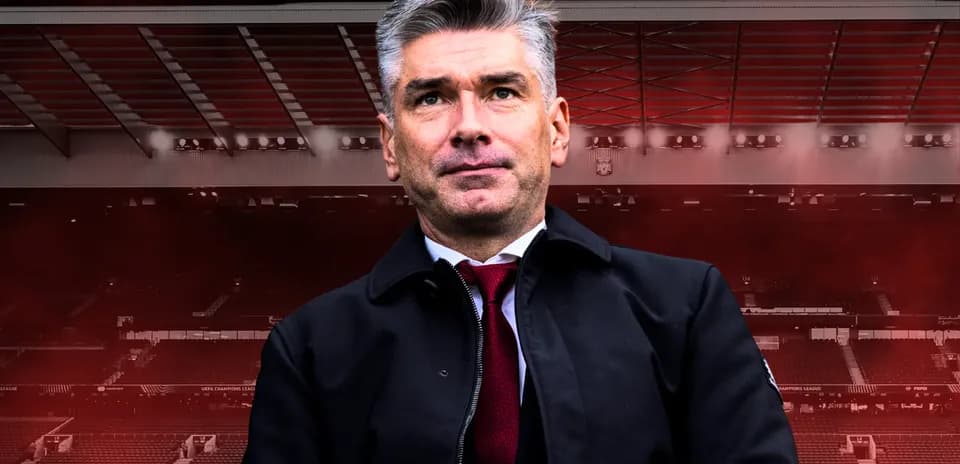 Coach standing in front of stadium backdrop