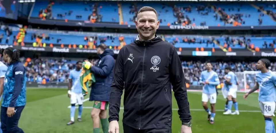 Manchester City coach smiling after the match