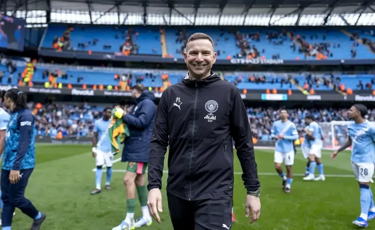 Manchester City coach smiling after the match