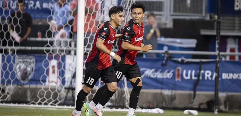 Two players celebrating a goal during match