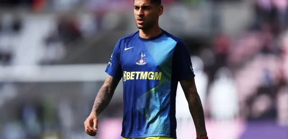 Player walking on the pitch in warm-up gear
