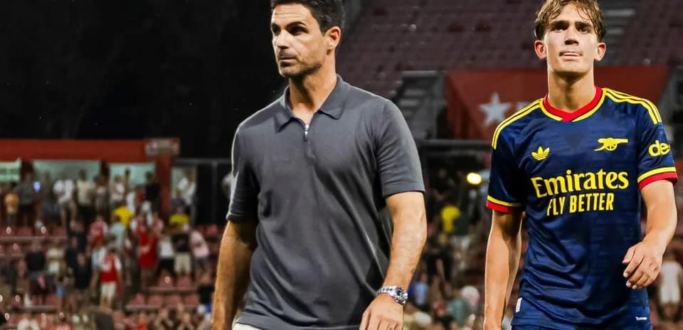 Coach and player walking off the field post-match